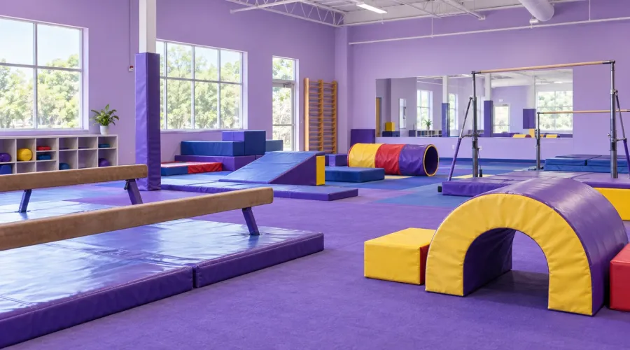A bright gymnastics gym with colorful padded equipment
